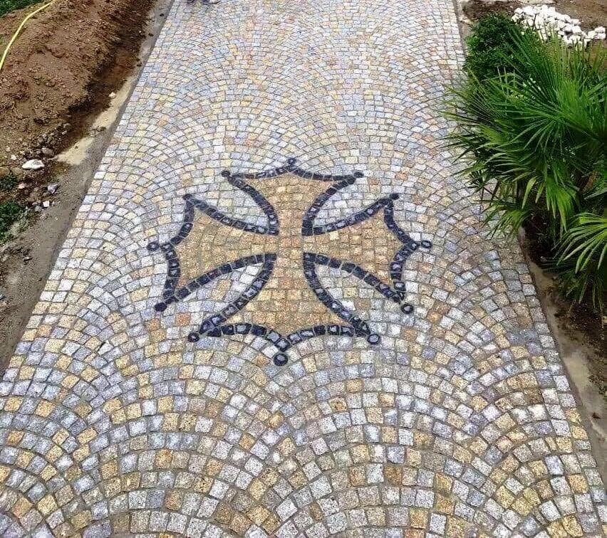 cobblestone pathway with ornate cross design